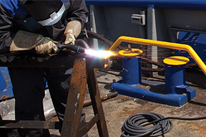 worker working with a plasma cutting torch