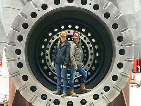 technicians in a dam rotator shaft