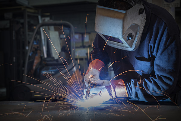 image of a worker using a MIG welder